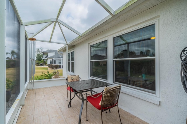 sunroom with vaulted ceiling with skylight