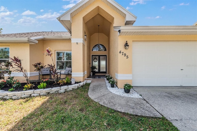 view of exterior entry with a garage