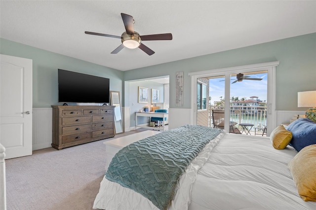 bedroom featuring access to outside, light colored carpet, and ceiling fan