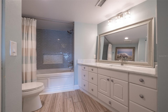 full bathroom with vanity, toilet, hardwood / wood-style floors, and shower / bath combo with shower curtain