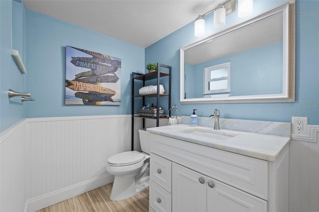 bathroom featuring vanity, toilet, and hardwood / wood-style floors