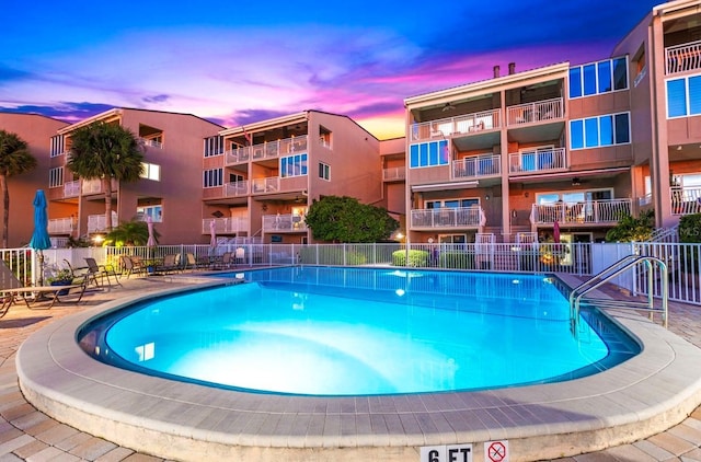 view of pool at dusk