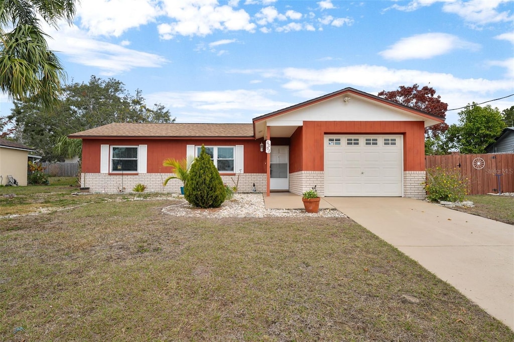 ranch-style house featuring a garage and a front yard