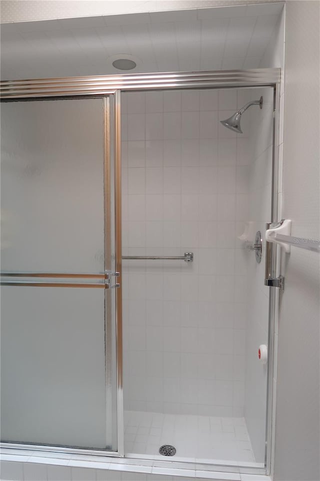 bathroom with a shower with door