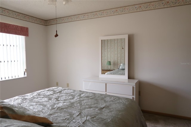 bedroom with carpet floors and multiple windows