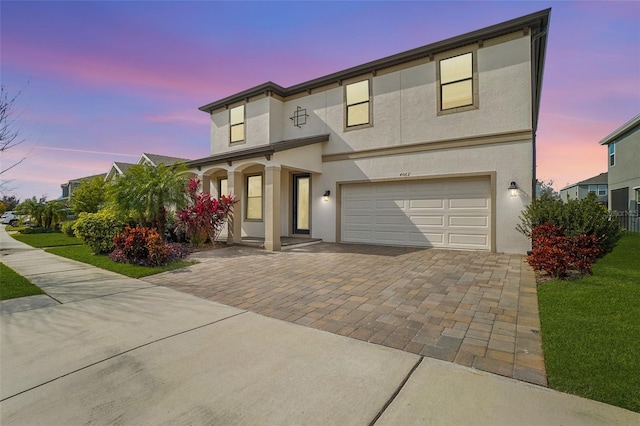 view of front of home featuring a garage and a lawn