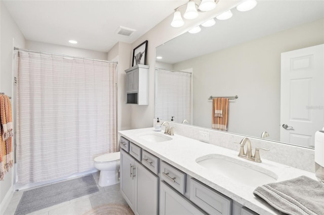 full bathroom featuring vanity, shower / bathtub combination with curtain, tile patterned floors, and toilet