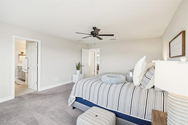 carpeted bedroom featuring ceiling fan and ensuite bath