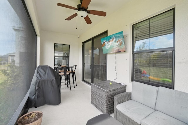 sunroom featuring ceiling fan