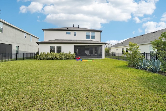 back of house featuring a sunroom and a yard