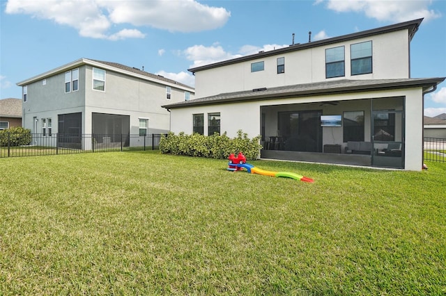 rear view of property with a playground, a sunroom, and a lawn