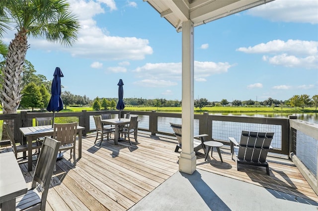 wooden terrace featuring a water view