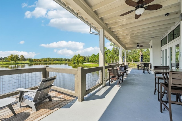 dock area featuring a water view and a patio area