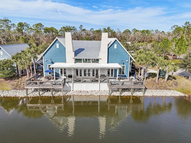 back of property featuring a deck with water view and french doors