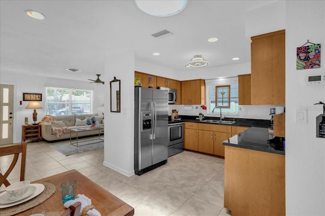 kitchen with ceiling fan, stainless steel appliances, and sink