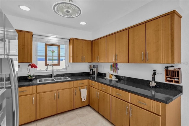 kitchen featuring stainless steel fridge, sink, and light tile patterned floors