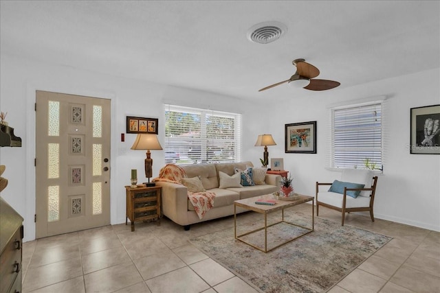 living room featuring ceiling fan, light tile patterned flooring, and visible vents