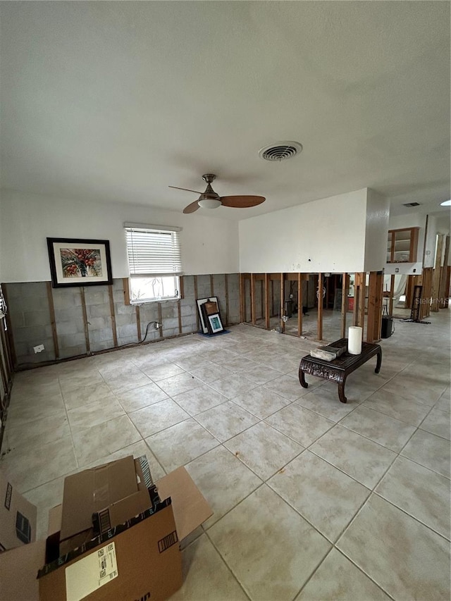 tiled living area featuring visible vents and a ceiling fan