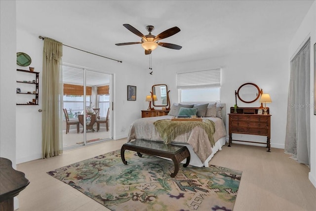 bedroom with wood finished floors, access to exterior, and ceiling fan