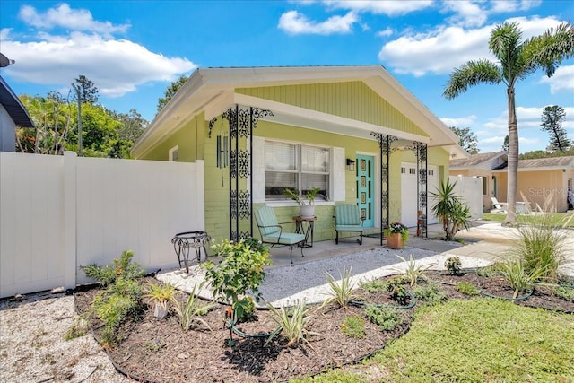 exterior space with covered porch and fence