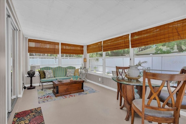 sunroom with a wealth of natural light and an outdoor living space