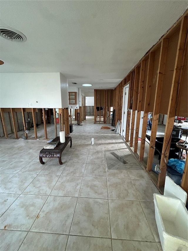 miscellaneous room featuring a textured ceiling, visible vents, and light tile patterned floors