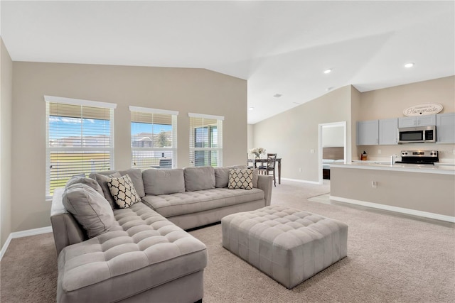 living room with lofted ceiling and light carpet