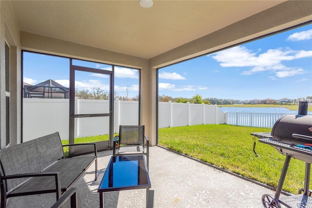 sunroom / solarium with a water view