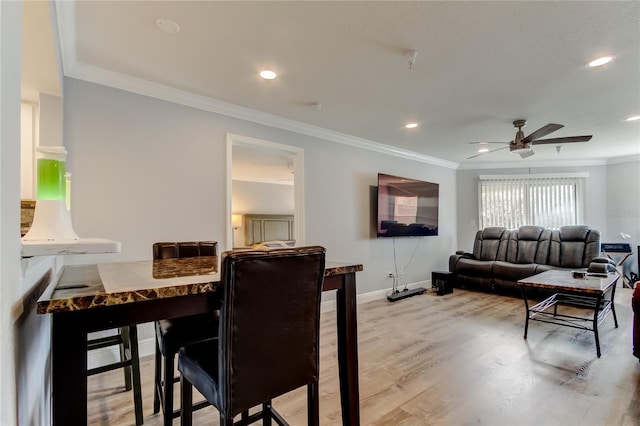 dining area featuring crown molding, hardwood / wood-style floors, and ceiling fan