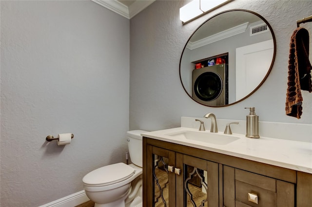 bathroom featuring crown molding, vanity, washer / dryer, and toilet