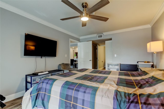 bedroom with ornamental molding, ceiling fan, and light wood-type flooring