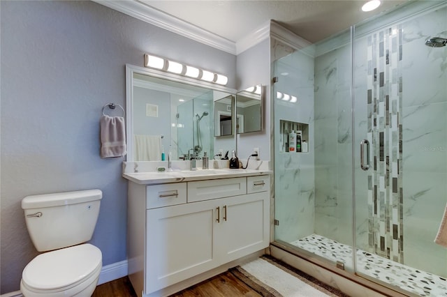 bathroom with crown molding, vanity, toilet, and walk in shower