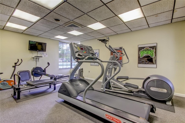 exercise area featuring a paneled ceiling and carpet