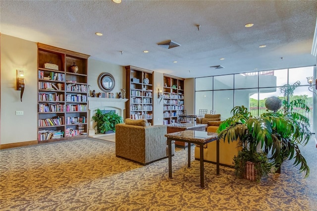 living area with a textured ceiling and carpet