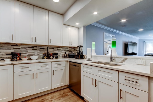 kitchen featuring sink, ornamental molding, stainless steel dishwasher, and white cabinets