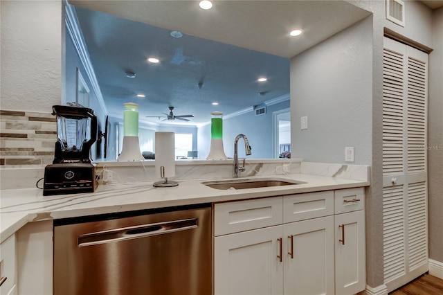 kitchen with dishwasher, light stone countertops, sink, and white cabinets