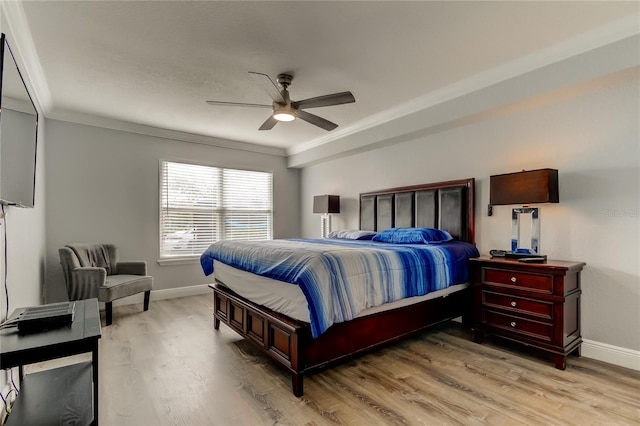 bedroom featuring crown molding, ceiling fan, and light hardwood / wood-style flooring