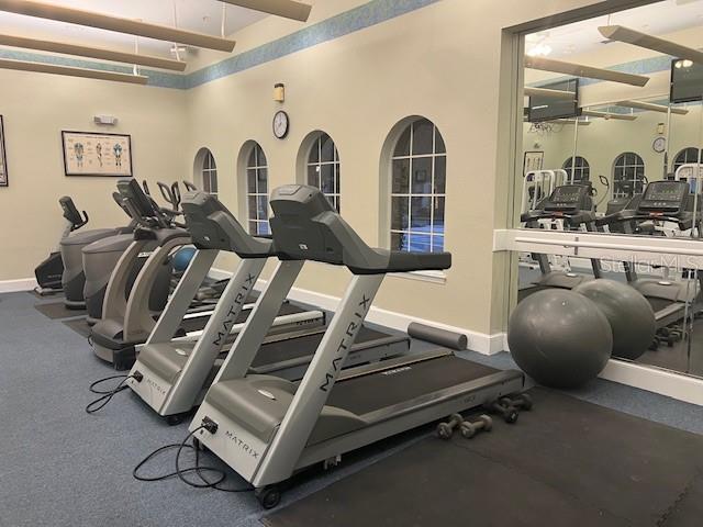 gym featuring a towering ceiling