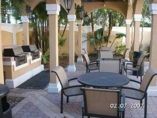 501 Knights Run Ave Unit 2119, Tampa, FL 33602 - view of patio with a grill, outdoor dining space, and exterior kitchen