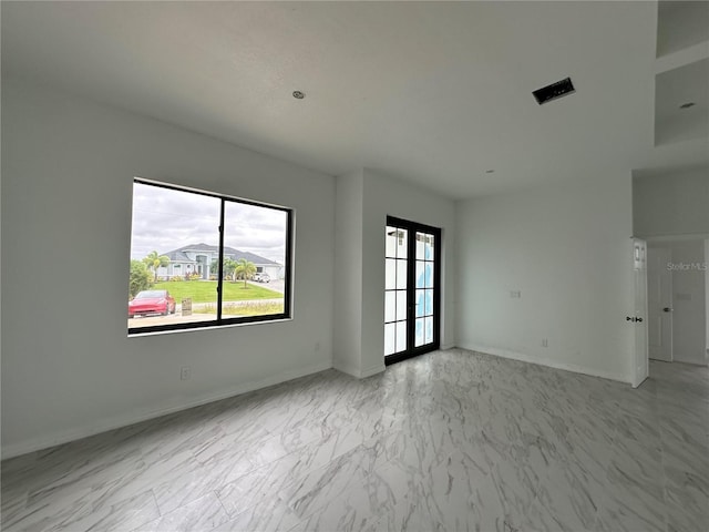 unfurnished room with french doors