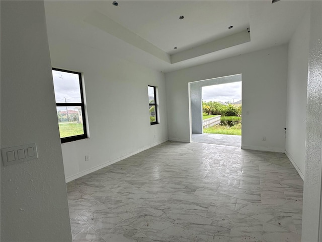 spare room with a tray ceiling