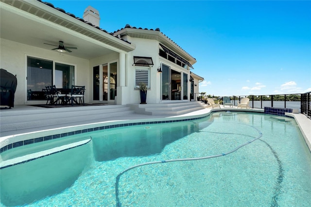 view of pool with ceiling fan, a grill, and a patio area