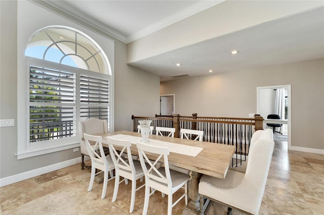 dining space with ornamental molding