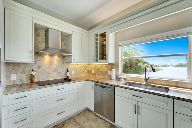 kitchen featuring dishwasher, sink, white cabinets, and wall chimney exhaust hood