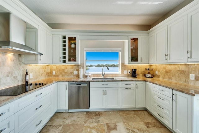 kitchen with wall chimney range hood, dishwasher, black electric stovetop, light stone countertops, and white cabinets