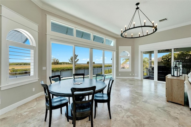 dining room with crown molding, french doors, a chandelier, and a water view