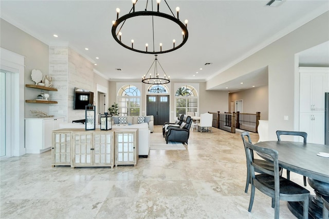 living room with crown molding and a notable chandelier