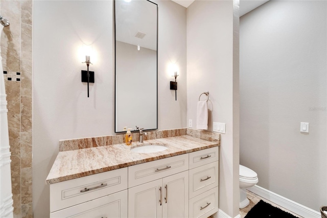 bathroom with vanity and toilet