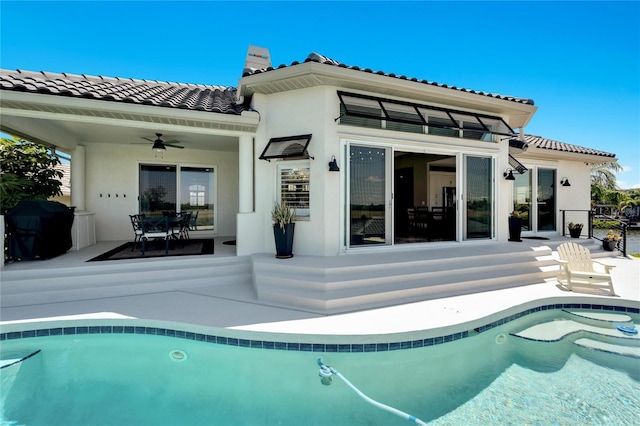 rear view of property featuring a patio area and ceiling fan