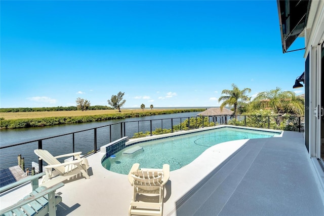 view of swimming pool featuring a water view